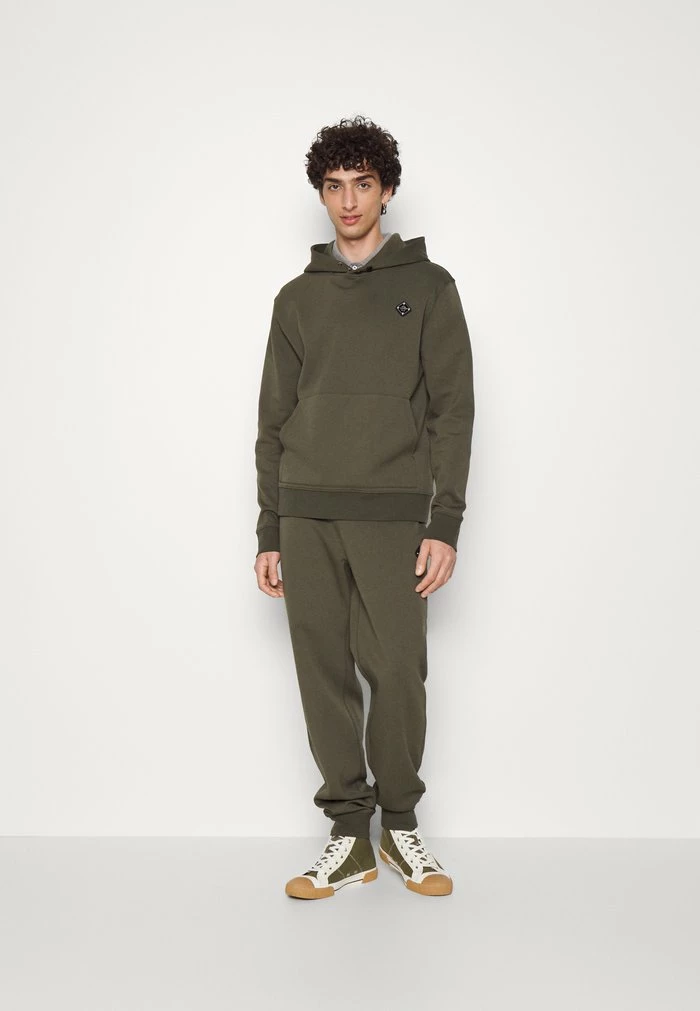 CREED - Tracksuit bottoms - forest green