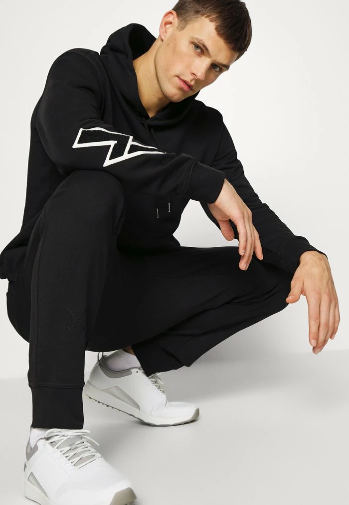 STRIKE - Tracksuit bottoms - black