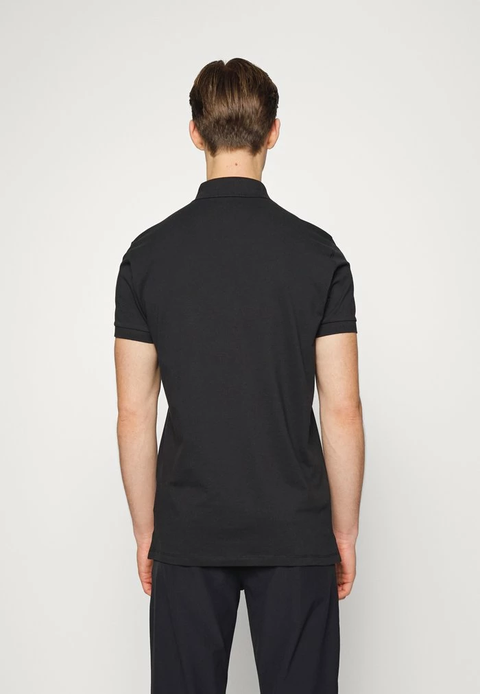 STRIKE - Polo shirt - black
